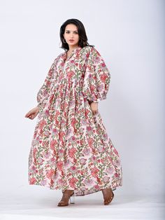 Designed with the freedom to flow with ease ~Our signature Buta Floral Dress in a palette of florals and Sumac spice. Handmade using the traditional method of block printing,an Indian artistry that has been passed down through generations.Her billowed sleeves and full flowing skirt reminisce with the magic of golden hues and sunset haze. Lovingly made with gratitude for our beautiful Mother Earth. Size: Waist :  S - M  : 90 cms Round ( fits upto uk 12) M - L.  : 100 cms Round ( fits upto uk 16) Pink Floral Print Dress With Relaxed Fit, Bohemian Maxi Dress With Floral Print In Relaxed Fit, Pink Floral Cotton Midi Dress, Traditional Floral Print Midi Dress For Spring, Flowy Cotton Floral Midi Dress, Traditional Spring Midi Dress With Floral Print, Pink Bohemian Cotton Midi Dress, Pink Bohemian Midi Floral Dress, Relaxed Fit Cotton Midi Dress With Floral Print