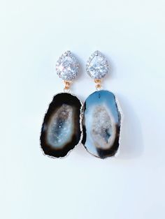 Meet, Gemma. One of our Signature styles. She features a Silver CZ post with a geode that is set in 24kt gold or silver. She can be customized and comes in other colors too. Please note, each geode is beautiful and unique. This is what makes each pair so special. Each stone is similar, but not exact. Please contact us directly to see images of the actual stone. CZ is also available in Rose Gold. Dimensions: 2” Luxury Agate Wedding Jewelry, Silver Geode Gemstone As A Gift, Silver Agate Geode With Natural Stones, Unique Handmade Gold Geodes, Gold Agate Jewelry For Wedding, Elegant Gold Geodes, Silver Geodes As Gift, Unique Silver Gemstone Geodes, Unique Silver Geode With Gemstone Details