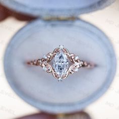 an oval shaped diamond ring in a box