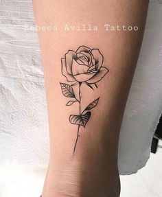 a small rose tattoo on the right side of the leg, it is black and white