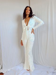 Glamorous V-neck Jumpsuit For Party, Glamorous V-neck Jumpsuits And Rompers For Party, Glamorous Sequined Jumpsuits And Rompers For Party Season, Glamorous Sequined Jumpsuits And Rompers For Date Night, Fitted V-neck Sequin Jumpsuit, Fitted V-neck Sequin Jumpsuits And Rompers, Fitted Sequin V-neck Jumpsuits And Rompers, Chic Evening Sequined Jumpsuits And Rompers, Chic Sequined Jumpsuits And Rompers For Date Night