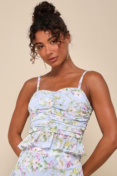 A cute OOTD like the Lulus Easily Beloved Light Blue Floral Ruched Ruffled Sleeveless Top is all you need to impress at your next event! Lightweight woven fabric, with a charming floral print and a burnout dotted design, shapes adjustable spaghetti straps and a subtle V-neckline. Ruched across the bodice lends a flattering effect, finishing with a cropped and ruffled hem. Exposed silver zipper at back. Pair with the matching skirt for a complete look! Fit: This garment fits true to size. Length: Summer Top With Smocked Bodice For Garden Party, Summer Garden Party Top With Smocked Bodice, Flirty Strapless Tank Top For Summer, Floral Print Sleeveless Tank Top For Party, Flirty Ruffled Tank Top For Summer, Spring Smocked Bodice Cami Tank Top, Spring Camisole Dress With Ruffles, Spring Cami Tank Top With Smocked Bodice, Spring Flirty Spaghetti Strap Tank Top