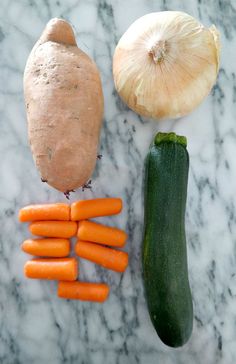 carrots, cucumber and onion on a marble surface