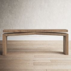 a wooden bench sitting on top of a hard wood floor next to a white wall