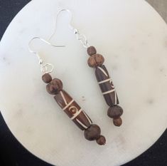 These fun wooden earrings add pizzazz to your outfit. Brown Wooden Bead Drop Earrings, Brown Wooden Bead Earrings, Brown Wooden Bead Earrings As A Gift, Brown Wooden Beads Beaded Earrings As A Gift, Unique Brown Wooden Beads Earrings, Brown Wooden Beaded Earrings As Gift, Brown Beaded Earrings With Wooden Beads For Gift, Brown Wooden Earrings For Pierced Ears, Gift Brown Beaded Earrings With Wooden Beads