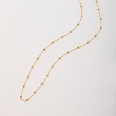 🌟 Elevate your style with our 14k solid gold satellite beaded ball chain necklace. This delicate and minimalist necklace features evenly spaced gold beads, making it perfect for layering or wearing alone. Ideal for everyday wear and special occasions, this timeless piece adds a touch of sophistication to any outfit. Perfect for birthdays, anniversaries, or just because. ✨ Perfect For:     Birthdays 🎉     Anniversaries 💕     Everyday Elegance 🌼 Order now to add a versatile and elegant piece to your jewelry collection! Material: Solid Gold (Not Gold Filled or Gold Plated) Gold Karat: 14 K Gold (585) Bead ball size: 1.8 mm, 2.0 mm Abundant Bead Ball Necklace; Ball size: 1.8mm Rare Bead Necklace; Ball size: 2.0mm You can customize the necklace length from 14 to 20 inches. Teen (Petite): 6. Rare Beads, Bead Ball, Beaded Ball, Beads Making, Everyday Elegance, Ball Chain Necklace, Ball Necklace, Minimalist Necklace, Ball Chain