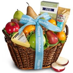 a basket filled with lots of different types of fruits and vegetables next to an apple