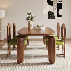 a wooden table with green chairs and a vase on top of it in front of a white wall