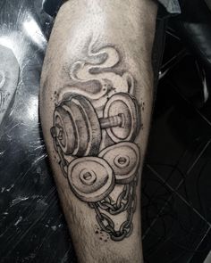 a black and white photo of a man's leg with dumbbells on it