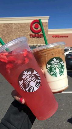 two starbucks drinks in plastic cups with straws