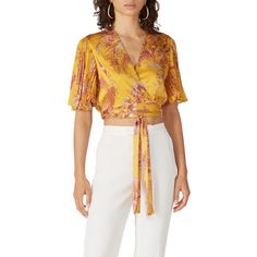 Yellow and pink printed chiffon (100% Polyester). Top. Short sleeves. V-neckline. Tie closure. Fully lined. 16" from shoulder to hemline. Imported. Feminine V-neck Printed Blouse, Silk V-neck Printed Tops, Feminine Yellow V-neck Blouse, Elegant Floral Print V-neck Top, Elegant V-neck Floral Print Tops, Yellow Floral Print Party Blouse, Party Yellow Blouse With Floral Print, Elegant Summer Blouse With Surplice Neckline, Elegant Surplice Neckline Blouse For Summer