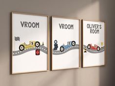 three framed posters with cars on the road in front of a wall mounted art piece