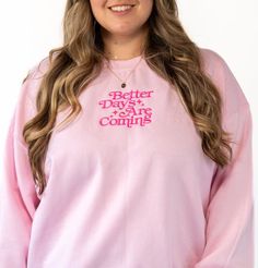 Whatever you're going through, just know there are better days ahead. This sweater is a great reminder of that. Featuring a retro embroidered font with the saying "Better Days Ahead" in hot pink across the center chest. This crewneck sweater has a slightly lighter exterior and runs a tad bit boxier and wider with stretch. For a fully loose oversized look, size up. This item is made to order in our shop so please allow up to one week processing time (we usually take less than that though). Detail Pink Relaxed Fit Crew Neck Sweater, Oversized Pink Sweatshirt With Slogan, Pink Sweatshirt With Text Print For Spring, Pink Text Print Sweatshirt For Spring, Pink Crew Neck Sweater With Text Print, Pink Cotton Sweater With Text Print, Pink Text Print Sweater For Winter, Pink Winter Sweater With Text Print, Pink Text Print Winter Sweater