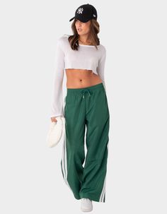 These Nylon Track Pants Offer Both Style And Comfort, Making Them Perfect For A Sporty Yet Fashionable Look. They're Ideal For Any Activity, Ensuring You Feel Comfortable And Confident Throughout Your Entire Day. Track Pants. Side Stripe Detail. Drawstring Waistband. 100% Polyester. Item Care: Wash With Similar Colors. Model Wears Size S. Model Height Is 5'8. | Edikted Fauna Nylon Track Pants Nylon Track Pants, Track Pants Outfit, Visionary Fashion, Track Pants Women, Side Stripe, Sport Pants, Pants Outfit, S Models, Bottoms Pants