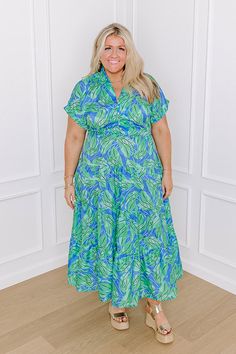 - Pose under the palms in this darling dress! With a botanical print and a timeless design, it is giving tropical vibes. Perfect for a seaside lunch date, this piece brings sunny-chic style to your wardrobe. - Unlined sleek material with a blue, white, black, and green hued botanical print - A collared v-cut neckline - A six buttoned bodice Short sleeves with rolled cuffs - A waistline with an elastic back - A flowy yet flattering silhouette that ends in a midi length hemline Concert Fashion, Long Sweater Dress, The Palms, Lunch Date, Swimwear Dress, Darling Dress, Sparkly Dress, Black Dresses Casual, Little White Dresses