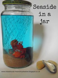 a glass jar filled with sand and sea shells