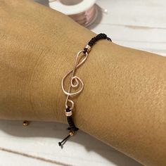 "This special and delicate Treble Clef Bracelet is a perfect gift for someone who loves music. As this is one of the most recognizable symbols in music it will be a very good way to shoe the world that you are a music lover.  It comes with a treble clef connector charm handmade of gold plated wire, on a macrame knotted nylon cord band and a very cute gold beads at the end of the adjustable strings.   I T E M ~D E T A I L S Materials: nylon and gold or silver plated wire charm and beads. Length: Adjustable Everyday Jewelry Band, Music-themed Bracelet Jewelry Gift, Trendy Band Bracelets As Gifts, Metal Band Jewelry As Gift, Music-themed Band Jewelry As Gift, Music-themed Band Jewelry Gift, Adjustable Friendship Bracelets Gift, Adjustable Band Friendship Bracelets As Gifts, Adjustable Metal Bracelet As A Gift For Her