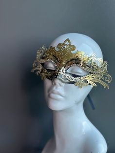 The set includes a striking gold and black mask for him and a captivating gold and black mask for her. The women's mask features a dramatic black feather, adding a touch of allure and mystique to her look. Whether you're attending a grand masquerade ball or a themed gala, this mask set ensures you'll be the center of attention.


Age Group/Gender - Adult/Unisex

Size/Type - One size fits all adults

Mask Color - Gold/Black

Mask Material - Polyresin

Special Features - Black feathers on the wome Gold Costume Masks For Halloween, Elegant Gold Mask For Masquerade, Gold Venetian Mask For Halloween, Gold Venetian Masquerade Mask For Halloween, Venetian Gold Masquerade Mask For Halloween, Elegant Mask For Carnival, Adjustable Full Face Mask For Masquerade, Elegant Carnival Mask Costume Accessory, Gold Eye Mask For Halloween Masquerade