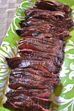 sliced beef on a green and white plate