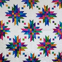 a quilt made with multicolored squares and stars on the front, back and sides