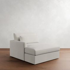 a white couch sitting on top of a wooden floor