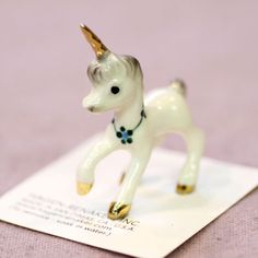 a small figurine of a unicorn on top of a white piece of paper