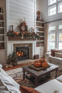 a living room filled with furniture and a fire place covered in pumpkins on top of a coffee table