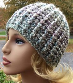 a mannequin head wearing a knitted hat