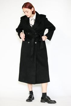 Indulge in timeless elegance with our Double-Sided Wool Black Wrap Coat. This heavyweight classic exudes sophistication and comes complete with a belt for versatile styling. The double-breasted design adds an extra layer of refinement, while the two pockets provide both style and convenience. What sets this coat apart is its full lining, ensuring comfort and warmth in every wear. Wrap yourself in luxurious fashion that effortlessly combines style and practicality. Elevate your winter wardrobe with this standout piece that promises both cozy comfort and chic allure. Composition: 100% Wool Heavyweight fabric Designed for a relaxed fit, fits true to size Made in New York SNOWXUEGAO.COM Elegant Notch Lapel Outerwear With Belt, Classic Belted Formal Outerwear, Formal Black Outerwear With Belt Detail, Elegant Fitted Outerwear With Belt Loops, Formal Black Belted Outerwear, Elegant Black Outerwear With Belted Cuffs, Classic Formal Outerwear With Belt Detail, Elegant Black Outerwear With Self Belt, Elegant Formal Outerwear With Belt