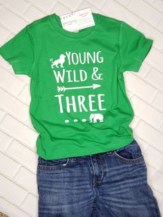 "When it comes to celebrating a 3rd birthday, a plain ol' shirt will never do! If your soon-to-be three year old is totally loveable but slightly wild? Does he LOOOOVE jungle animals? Then this \"Young Wild & THREE\" shirt will be a perfect match for your lil guy! ------------------------------------------------------------- 3rd Birthday shirt: All shirts are short-sleeve and fit true-to-size (boutique brand) - Long-sleeve shirts are available by special order. Please contact us before order Green Graphic Print T-shirt For First Birthday, Playful Green T-shirt For Birthday, Green T-shirt With Letter Print For First Birthday, Green Casual Top For First Birthday, Green Short Sleeve Top For First Birthday, Birthday Letter Print Green Shirt, Green Short Sleeve Shirt For Birthday, Third Birthday Boys, 3rd Birthday Shirt