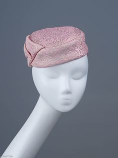 Jackie is a chic, elongated button-shape fascinator completed with a large charismatic bow. The mini hat sits comfortably on the top of your head and should be worn slightly towards right. This  headpiece is hand formed and sewed, making it an exclusive design. This artisan cocktail fascinator will appeal most when worn to complement classic outfits comprising cream, gold or shades of pink. *Handmade item *Style: Jackie *One size fits all *Fabric: pink silk, gold jacquard *Ships worldwide from Poland *More products available on www.joremi.co.uk For the customisation option, please contact me via 'Request a custom order' button at the top of the page. Please note that due to the nature of this handmade artisan headwear, making a second entirely identical item is not possible. We can discuss Kentucky Derby Evening Hat With Satin Bow, Elegant Evening Hat With Satin Bow, Elegant Formal Hat With Bow, Fitted Evening Hats With Bow, Evening Hat Shaped Headband For Royal Ascot, Evening Hat With Bow For Royal Ascot, Elegant Formal Fascinator With Satin Bow, Evening Hats With Bow And Short Brim, Fitted Cloche Fascinator For Evening