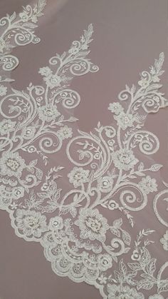 white lace on pink fabric with flowers and leaves