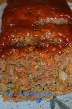 the meatloaf is covered with sauce and vegetables