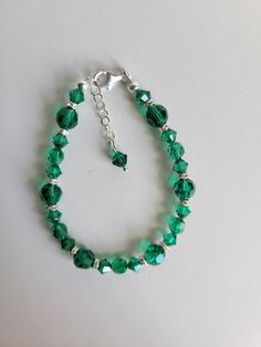 "This bracelet is made with a new Swarovski crystal color, Majestic Green, 6mm/8mm round crystal with 6mm Clear AB rondelle crystal. The remainder of the beads and the findings are sterling silver. It has a 1\" extension with a beaded drop making it adjustable. Custom Orders are always welcome! Ask about free sizing." Faceted Round Bead Bracelets For May Birthstone, Faceted Round Beads Bracelet For May Birthstone, Silver Crystal Bracelets With 8mm Beads, Silver Crystal Bracelets With Beads, Green Crystal Round Bracelets, Sterling Silver Crystal Bracelet With Round Beads, Green Crystal Round Beads Bracelets, Green Crystal Beaded Bracelets With Round Beads, Elegant Faceted Czech Glass Bracelets