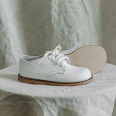 The Harvey Oxford is made of white full grain leather and lined with breathable leather and cotton which work together to draw out any moisture. The structure of the shoe and the rubber sole provide stability without weight to support your child's early steps. The perfect style to dress up or down! Classic White Lace-up Leather Shoes, Classic Leather Walking Shoes With White Sole, White Non-slip Lace-up Walking Shoes, Everyday White Leather Walking Shoes, Classic Walking Shoes With White Rubber Sole, Classic Walking Shoes With Textured Sole, White Leather Walking Shoes With Rubber Sole, Everyday White Low-top Walking Shoes, White Walking Shoes With Rubber Sole For Everyday Use