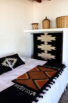 a black and white blanket on top of a bed