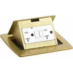 a gold plated electrical outlet with two white outlets