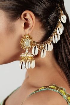 Gold and white finish jhumkas studded with pearls, shells, chid and has a ear chain. Type: Shell, Chid, Pearls Color: White,Gold Shell drops Size: L x W (in cms): 9 x 4 Weight (in gms): 92 Closure: Fish hook - Aza Fashions Bhavya Ramesh, Diy Jewellery Designs, Ear Chain, Jewellery Earrings, Jewelry Indian, Jhumka Earrings, Shell Jewelry, Punjabi Suits, Shell Beads