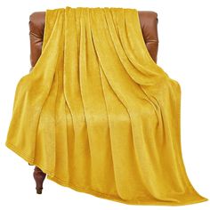 a chair with a yellow blanket draped over it