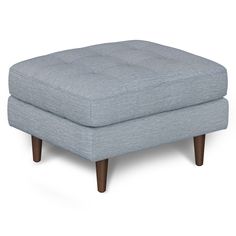 a blue ottoman with wooden legs on a white background