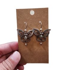 These vintage drop earrings are a must-have for any jewelry collection. The butterfly shape is a classic and timeless design that is sure to catch the eye of anyone who sees them. Made from high-quality 925 china sterling silver, these earrings are durable and long-lasting.  The dangle/drop style adds an elegant touch to any outfit, making them perfect for both casual and formal occasions. The 1.5" length is just right for the average earlobe, and the silver color complements any skin tone. These earrings were made in China and have a rich history that adds to their unique charm. Add them to your collection today and enjoy the beauty and timeless elegance they bring. Elegant Silver Butterfly Earrings, Classic Silver Earrings As Gift, Classic Silver Earrings For Gift, Silver Butterfly Earrings With Ear Wire, Silver Butterfly Earrings For Formal Occasions, Nickel-free Silver Butterfly Earrings, Nickel-free Butterfly Shaped Silver Earrings, Vintage Sterling Silver Hypoallergenic Earrings, Vintage Hypoallergenic Sterling Silver Earrings