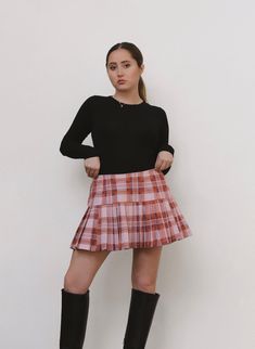 This Pink Plaid Mini Skirt is the perfect preppy piece to add to your wardrobe! Features an invisible zipper closure in the back. Looks great styled with knee high boots and a simple top. Sustainably made from vintage deadstock fabric. Model Measurements: Waist: 28 Hips: 34 Height: 5' 1 Pink Plaid Skirt Outfit, Pink Plaid Skirt, Green Midi Skirt, Plaid Skirt Outfit, Plaid Pleated Mini Skirt, Plaid Pleated Skirt, Womens Skirts, Simple Top, Purple Plaid