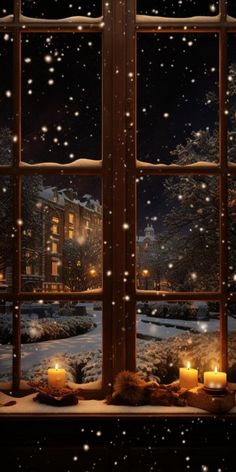 a window with candles lit in front of it and snow falling on the windowsill