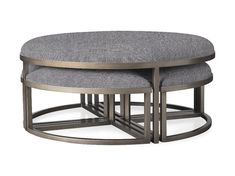 two round tables with grey upholstered cushions on each side and one sitting on the other