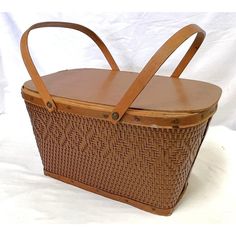 a brown basket sitting on top of a white table