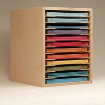 a wooden box with many different colored papers in the bottom drawer and inside compartments on each side