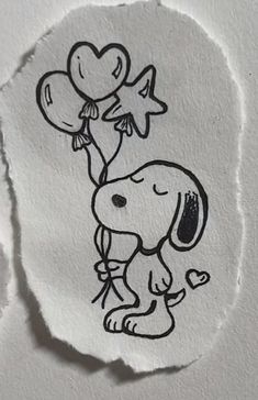 a piece of paper with a drawing of a dog holding balloons on it's head