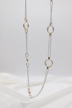 This Gold & Silver Cable Floating Dig Circle Double Belcher Necklace is expertly crafted and designed to elevate any look. Made from high-quality gold and silver, this necklace features a unique floating dig circle design and a double belcher chain for a modern and luxurious touch. A must-have for any jewelry collection. Length: 36 inches Circle: 1.13” Width Closure: Lobster Claw Material: Brass with 18K Gold Plating and Rhodium Coating Lead Free and Hypoallergenic Belcher Chain, Circle Design, Tennis Bracelet, Gold And Silver, Gold Plating, Lobster Claw, Silver Gold, Jewelry Collection, Floating