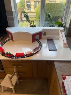 a model train set sitting on top of a kitchen counter