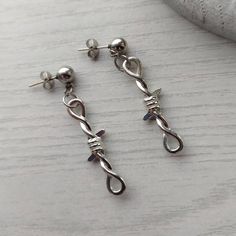 Trendy punk/goth style barbed wire earrings in silver! Unisex Ball studs measure 6mm and are made of stainless steel so are hypoallergenic. Barbed wire charms are made of zinc alloy and measure 34mm in length. Available as a single earring or as a pair. Please don't hesitate to contact me with any queries or suggestions 😊 Comes gift wrapped 💝 Edgy Silver Plug Earrings As A Gift, Edgy Silver Plug Earrings For Gift, Alternative Style Pierced Earrings As Gift, Alternative Style Pierced Earrings For Gift, Silver Pierced Grunge Earrings, Punk Pierced Earrings For Streetwear, Edgy Nickel-free Piercings As Gift, Nickel-free Edgy Piercings As Gift, Silver Grunge Pierced Earrings